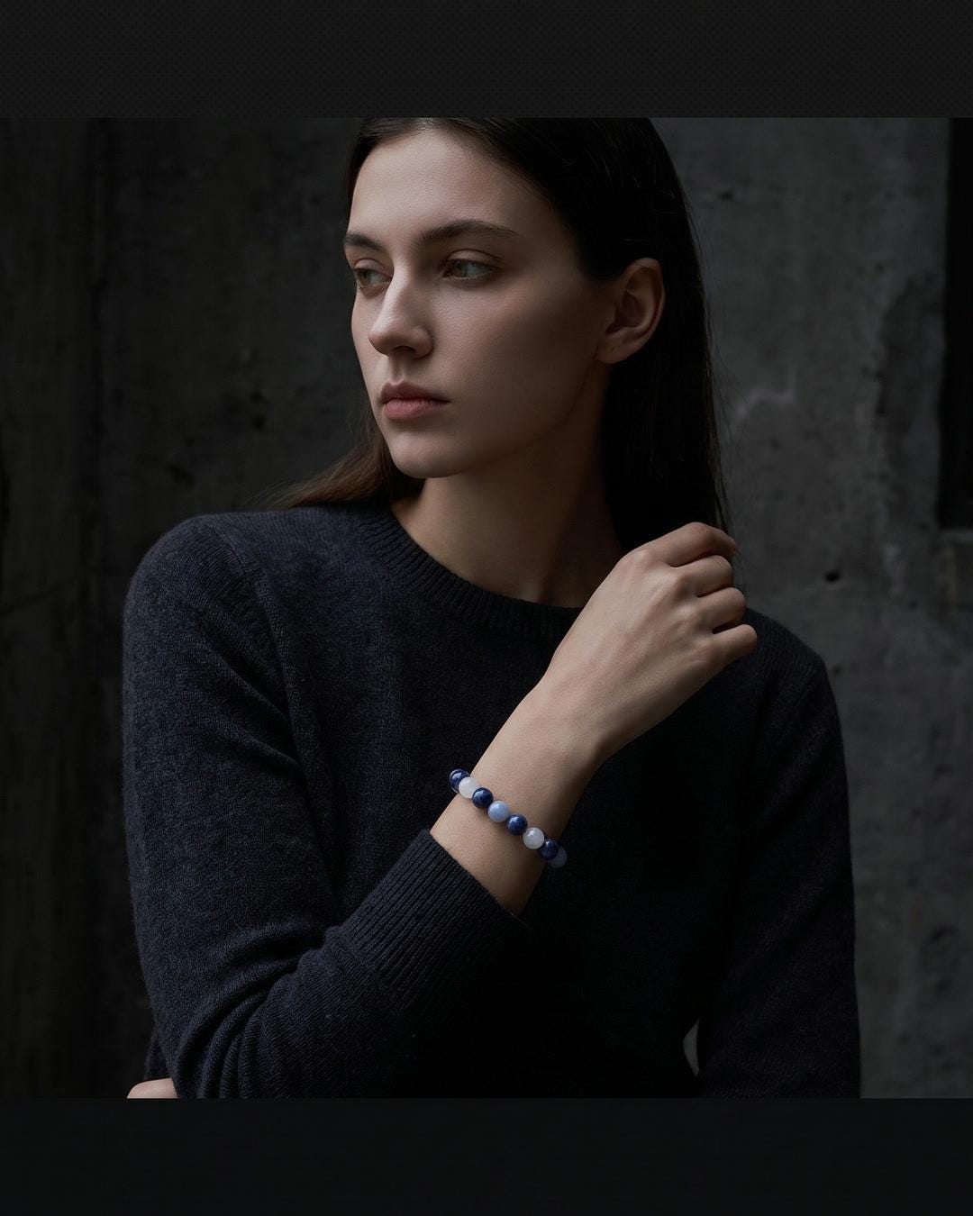 Celestial whimsigoth beaded bracelet worn on a wrist alongside stacked silver rings