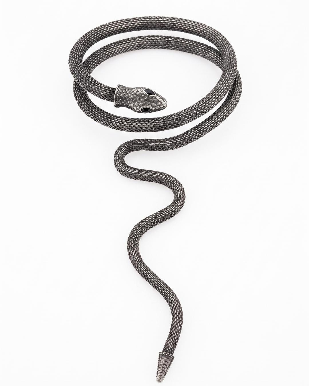 Close-up of a silver serpent wrap collar coiled twice with a long tail drop and scale mesh body.