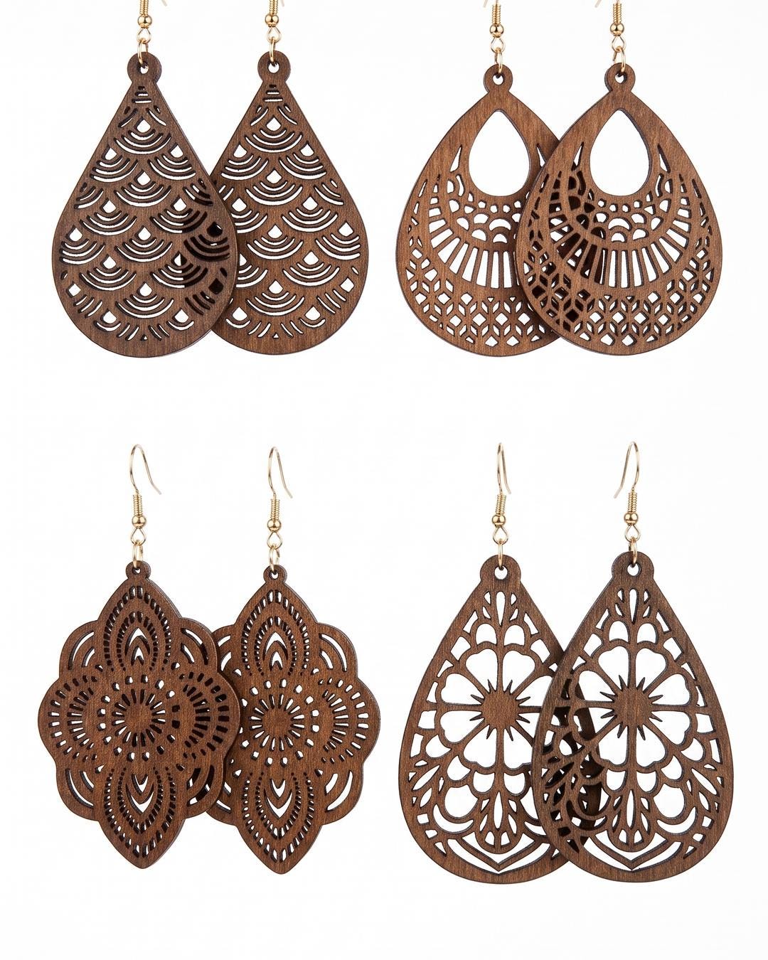 All four wooden laser-cut floral pendant earrings laid flat, showing mandala, lace, scalloped, and heart designs.