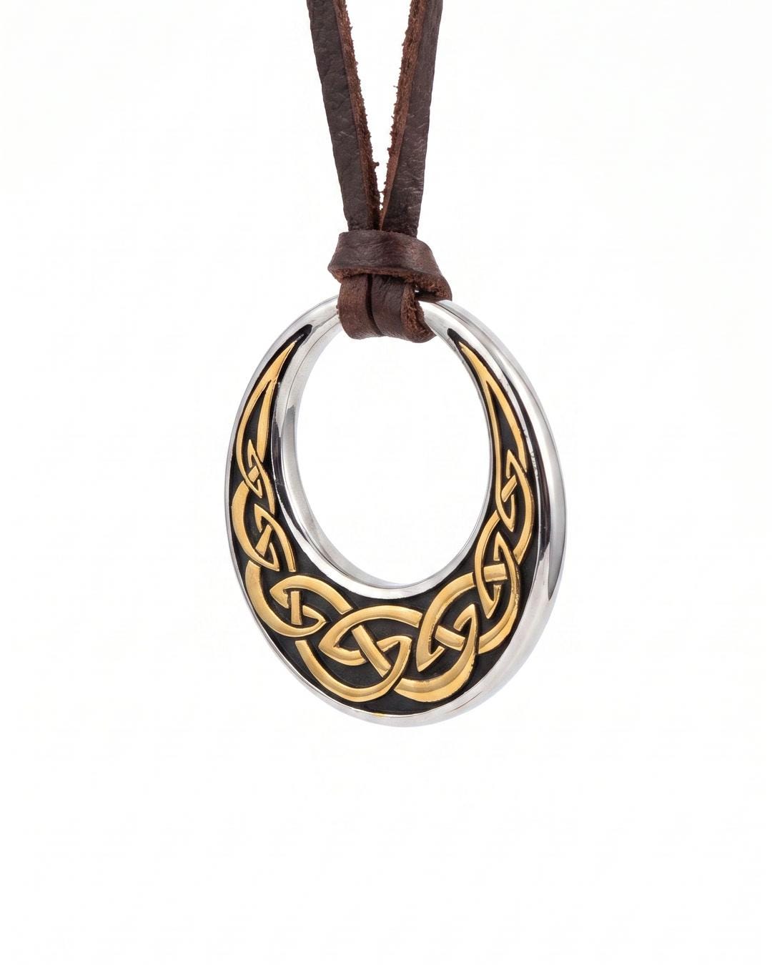 Celtic knot crescent moon necklace worn long over a dark high-neck knit, pendant resting at chest level